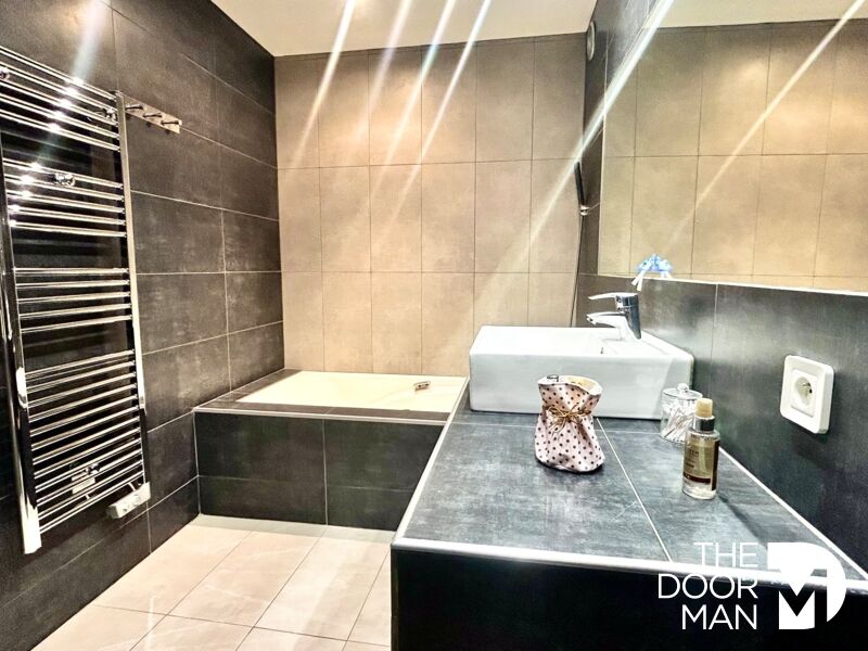 Modern bathroom Modern bathroom with bathtub and sink, grey tiles.