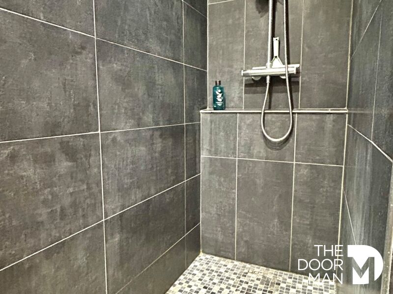 Modern shower Modern shower with grey tiles and bathroom accessories.