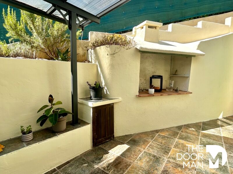 Outdoor area with barbecue Outdoor space of a house with a barbecue area and plants.