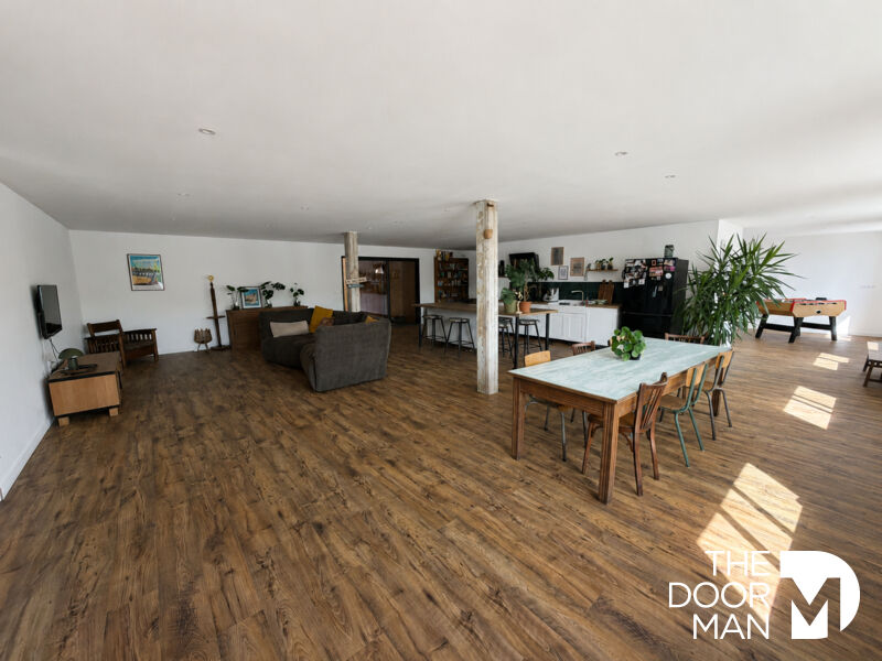 Spacious interior of a house with living room, dining room and open kitchen, abundant natural light.