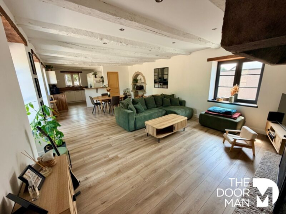 Interior of a stone farmhouse with spacious living room and open kitchen in Aucaleuc.