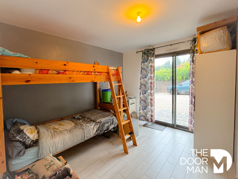 Room with bunk beds Bedroom in a contemporary house with bunk beds and access to the outside.
