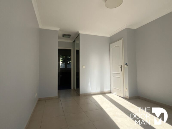 Interior of a house in Limours, bright room with tiled floors and light-colored walls.