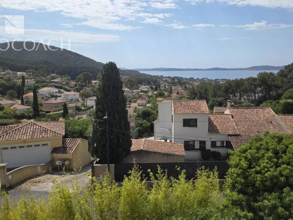 Vue panoramique d'une maison contemporaine à Carqueiranne avec vue sur la mer et les collines environnantes.