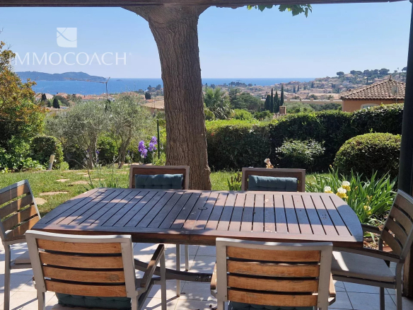 Sea view from a villa with garden in Carqueiranne, wooden table in the foreground.