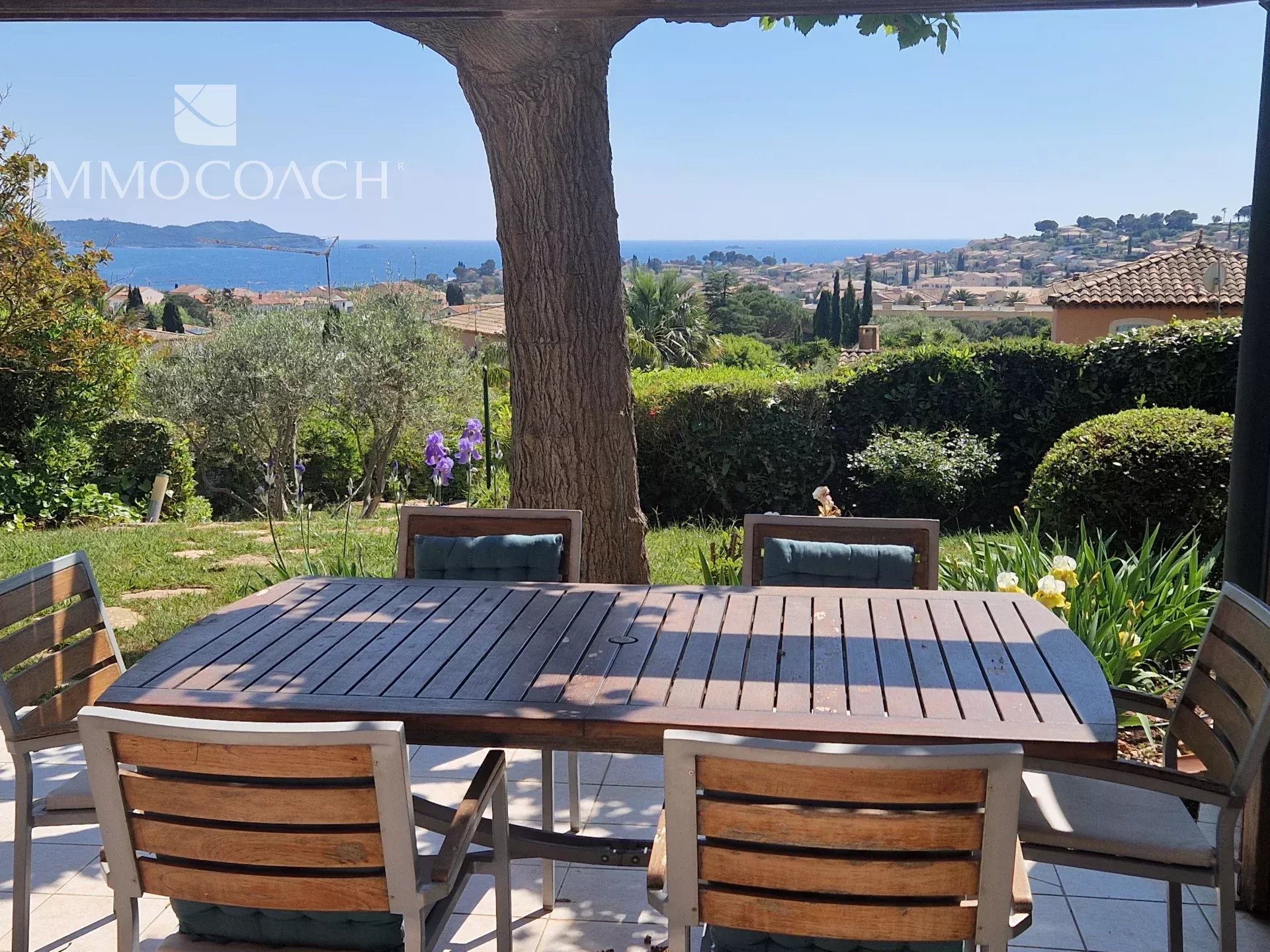 Villa with sea view in Carqueiranne Sea view from a villa with garden in Carqueiranne, wooden table in the foreground.