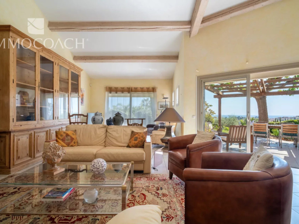 Interior of a villa in Carqueiranne with sea view, bright living room and comfortable furniture.