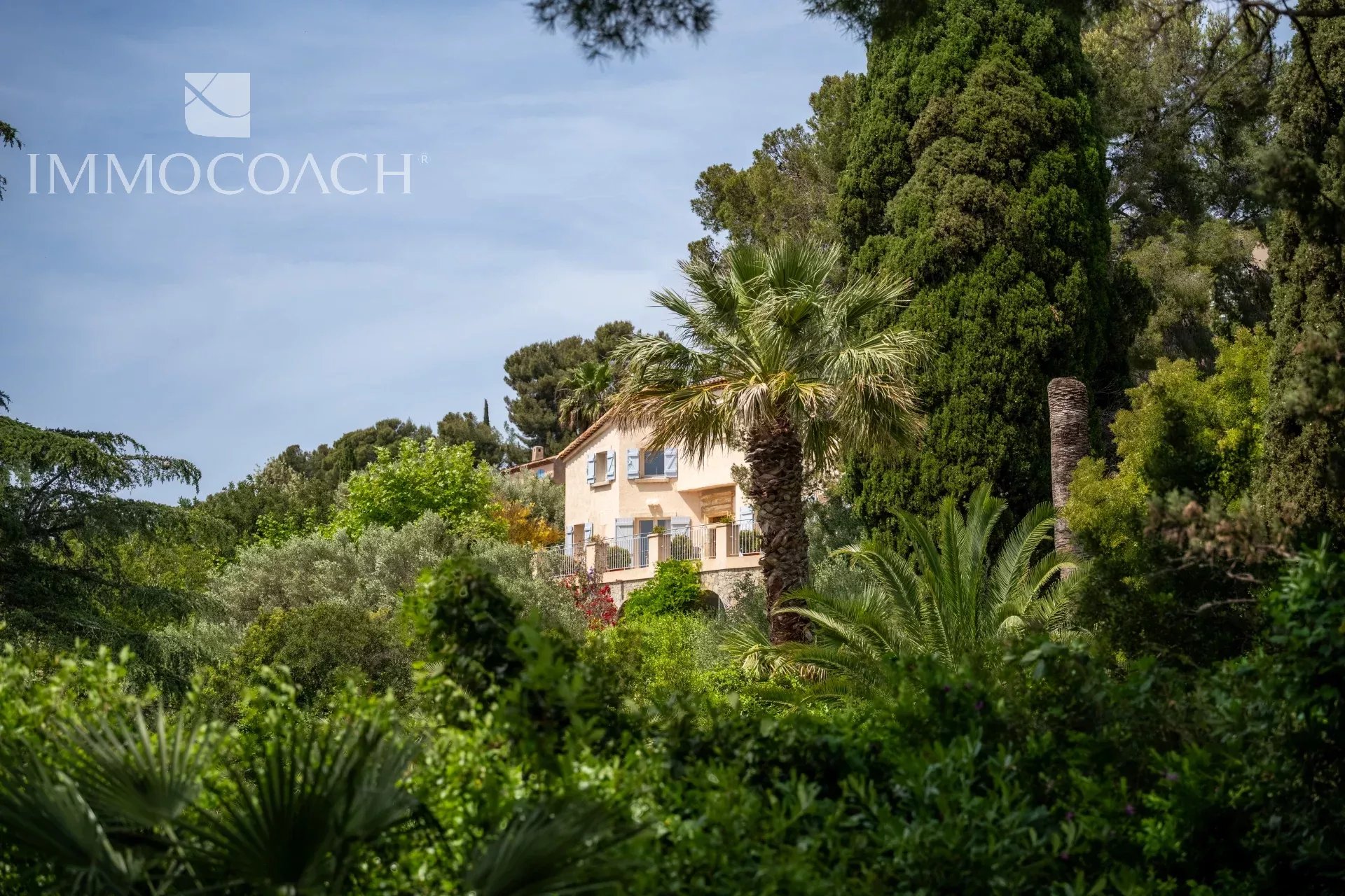 Property surrounded by greenery with sea views in Carqueiranne, swimming pool visible in the garden.