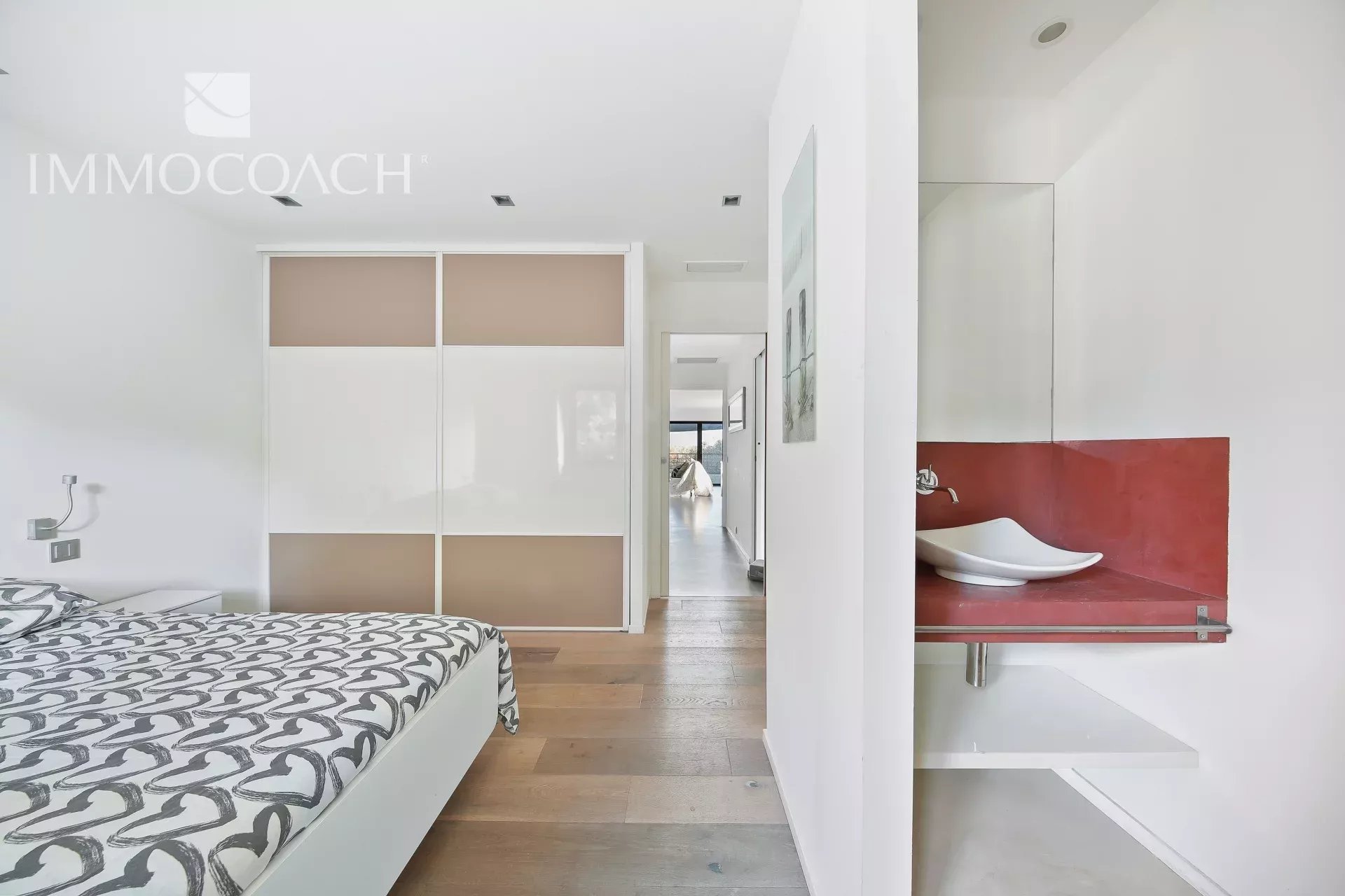 Modern bedroom with bathroom Interior of a modern bedroom with bed and en suite bathroom in a villa.