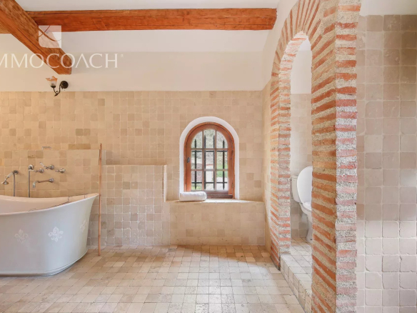 Bathroom in a bastide (traditional Provençal farmhouse) with bathtub and stone walls in Collobrières