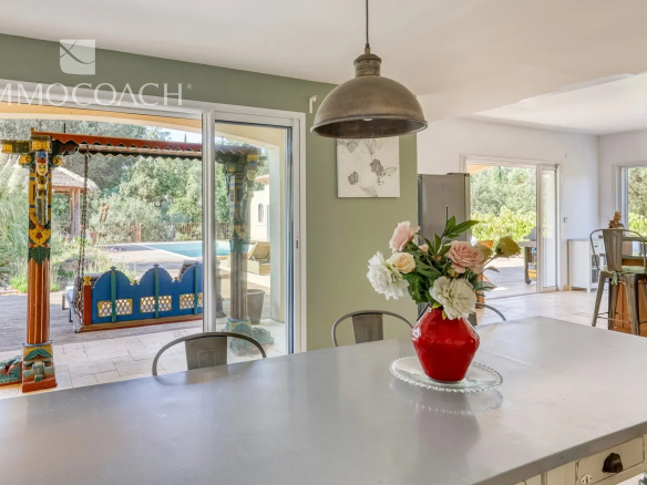 Interior of a neo-Provençal villa with open-plan kitchen and pool view