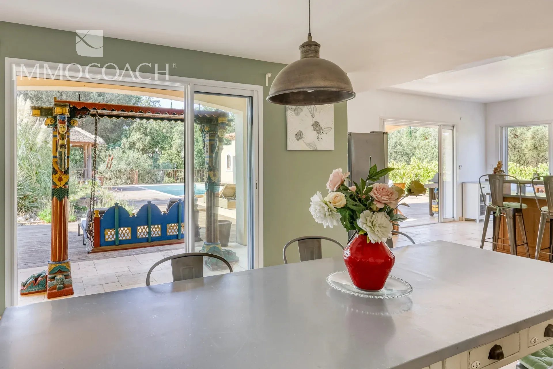 Interior of a villa in Bormes-les-Mimosas Interior of a neo-Provençal villa with open-plan kitchen and pool view