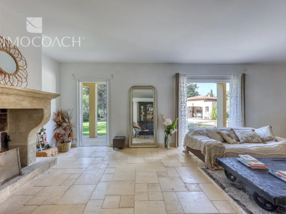 Interior of a neo-Provençal villa with bright living room and fireplace, Bormes-les-Mimosas.