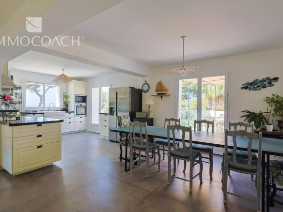Interior of a renovated house with a modern kitchen and spacious dining room.