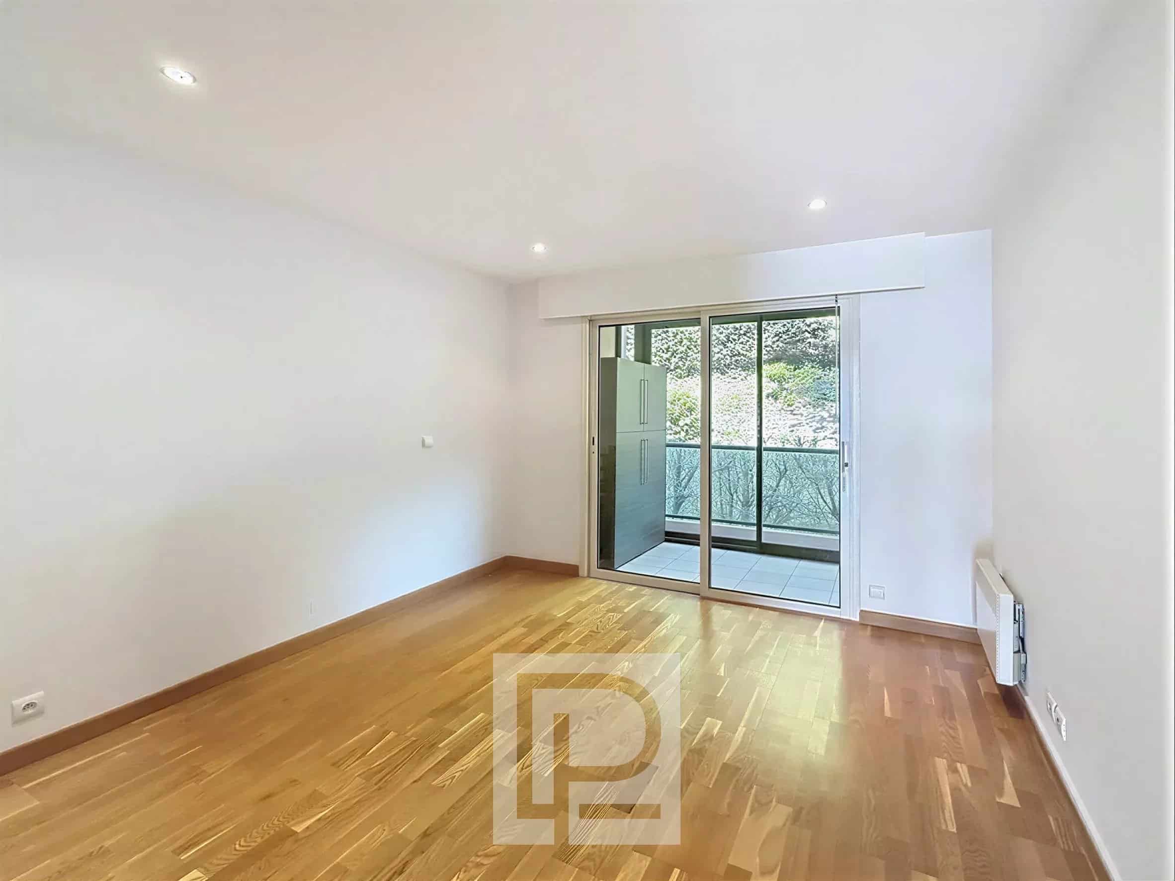 Appartement 3 pièces à Le Cannet Intérieur d'un appartement vide avec parquet et accès à un balcon.