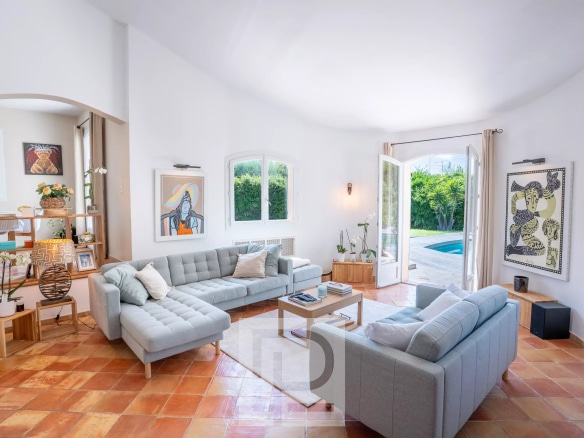 Intérieur d'une villa provençale rénovée avec salon lumineux et accès à la piscine.