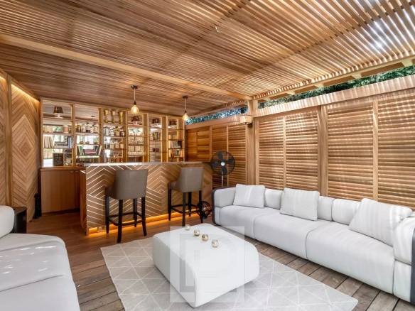 Modern living room with bar, white sofas and warm lighting in an artist's house in Cannes.