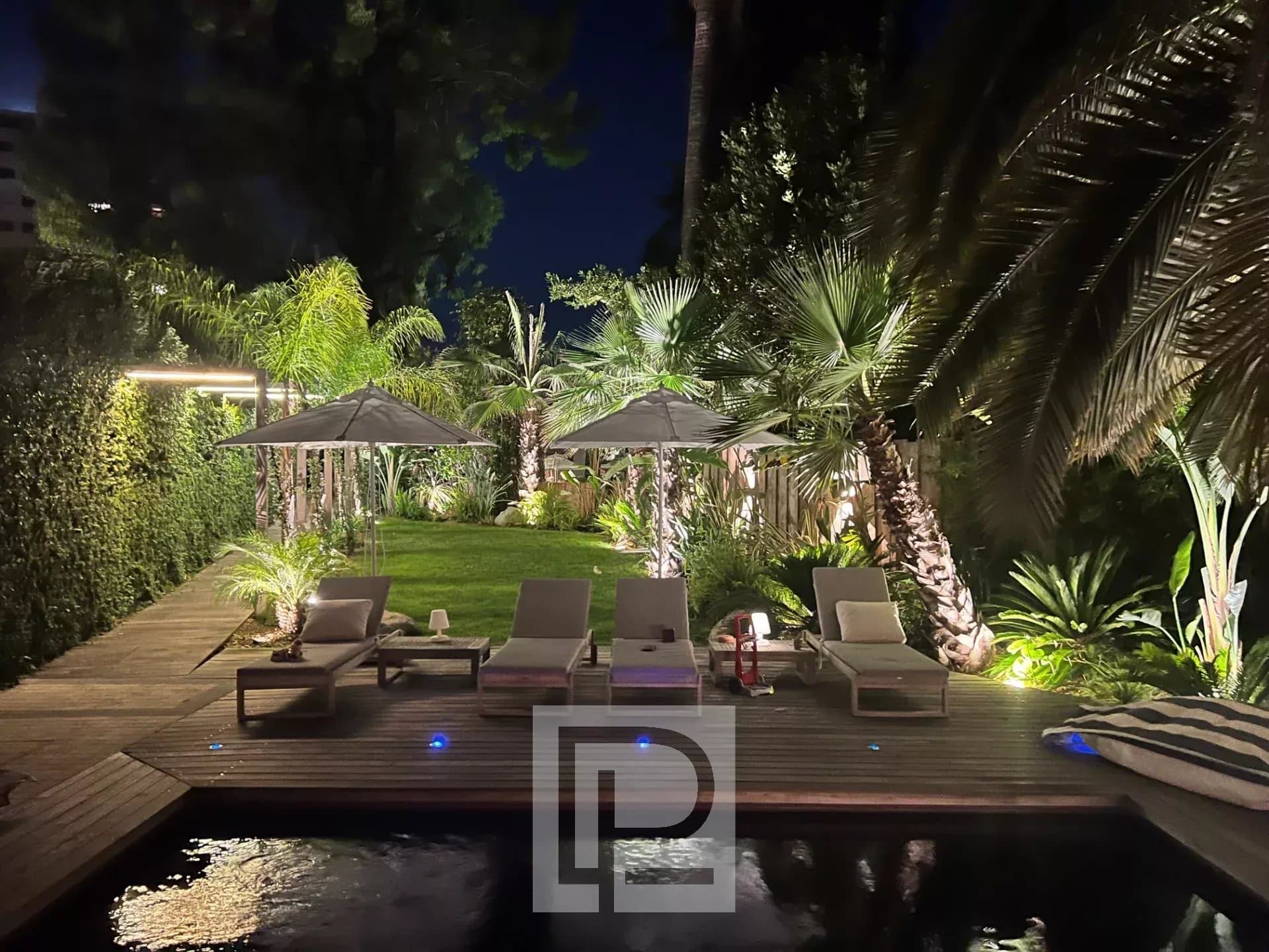 Garden of an artist's house in Cannes with sun loungers and parasols
