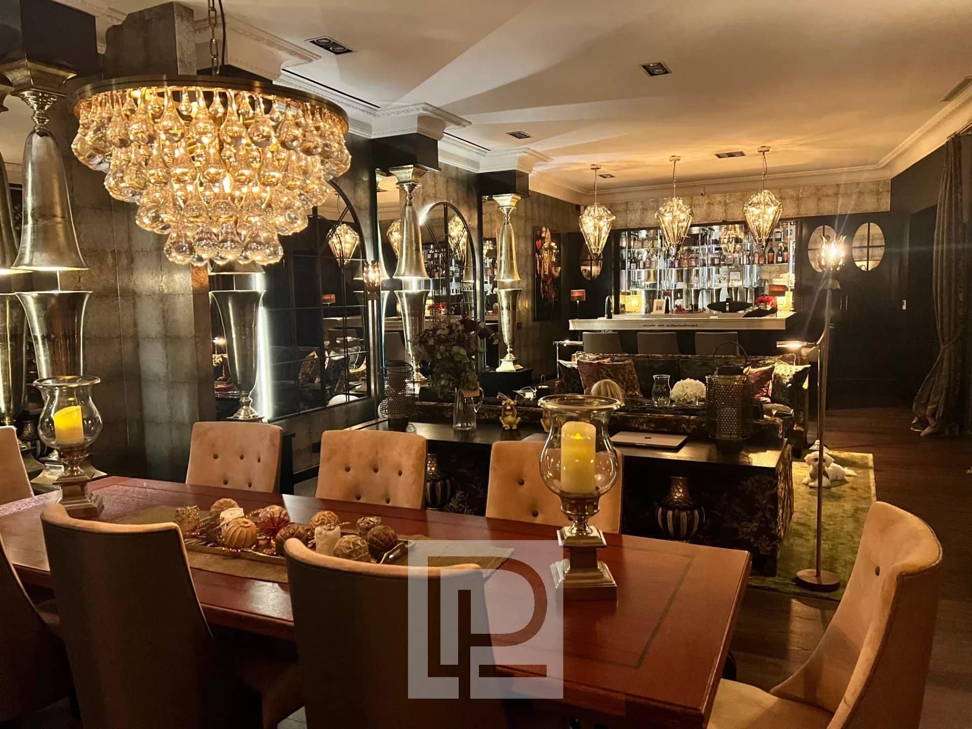 Interior of an artist's house in Cannes with chic baroque decor, dining table and bar.