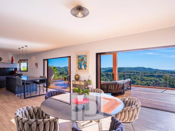 Interior of an elegant property with panoramic views of nature and the sea.