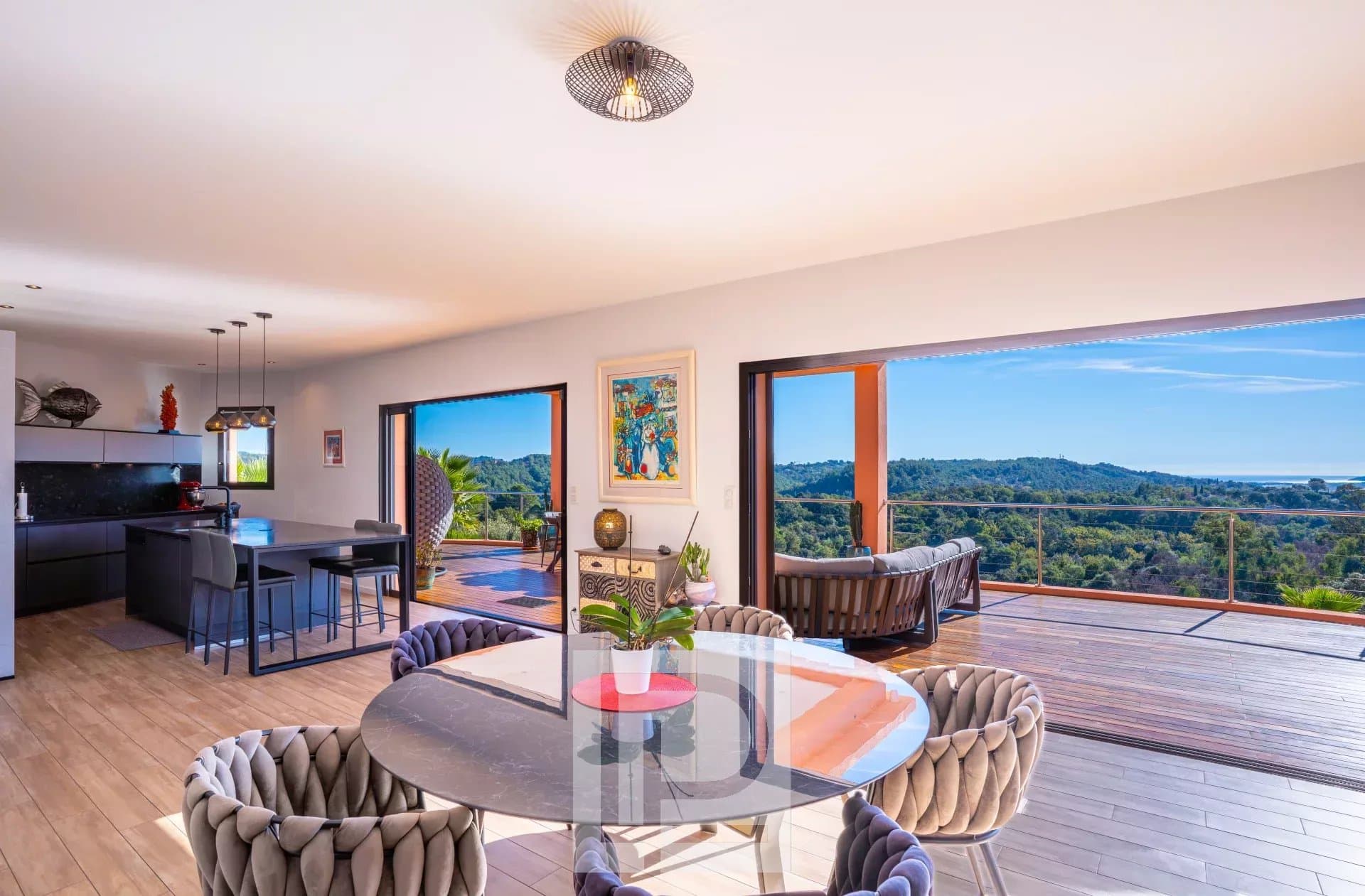 Interior of an elegant property with panoramic views of nature and the sea.