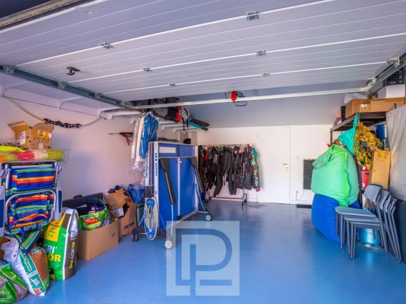 Interior of a garage with various equipment and storage.