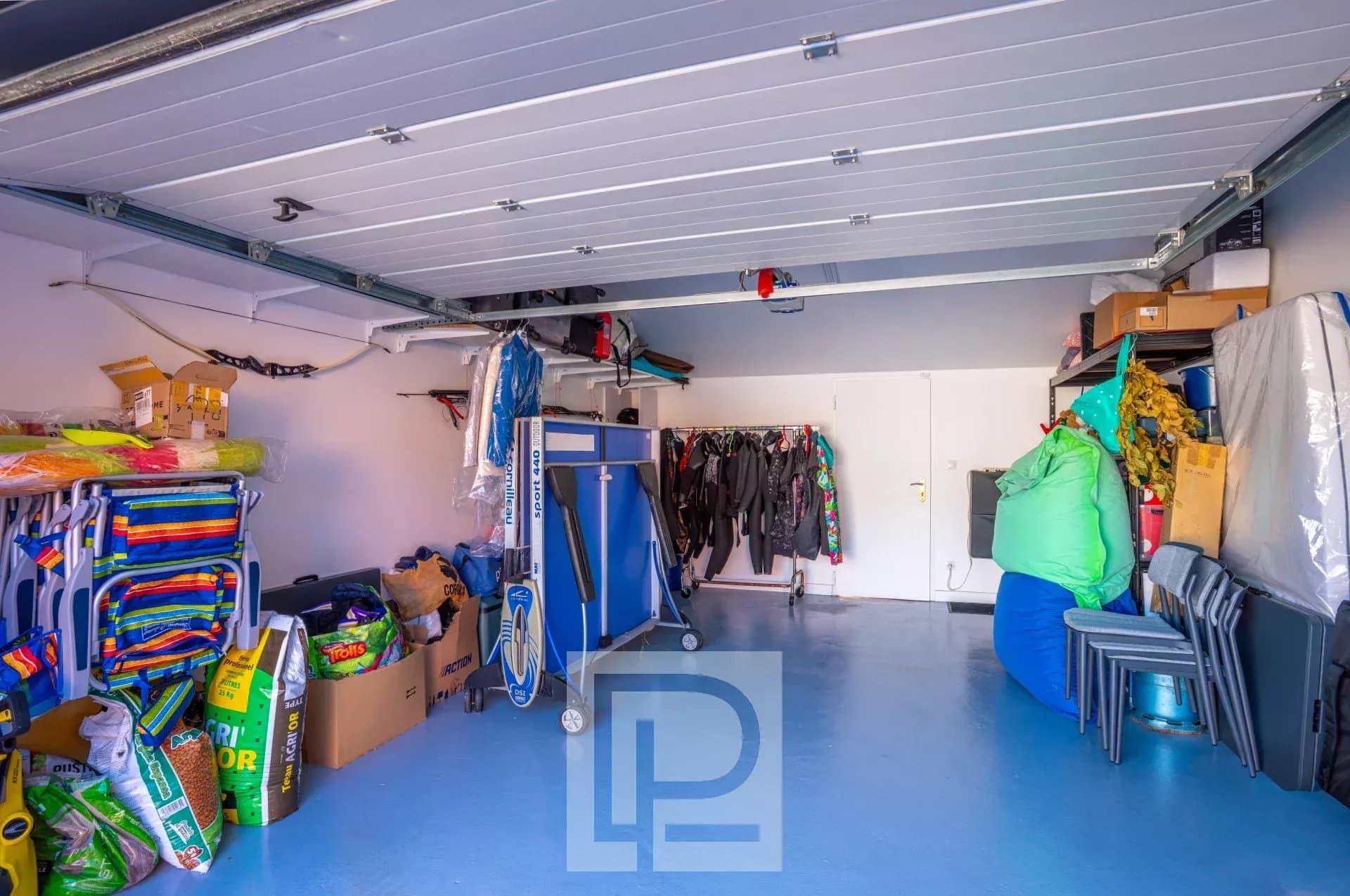 Interior of a garage with various equipment and storage.