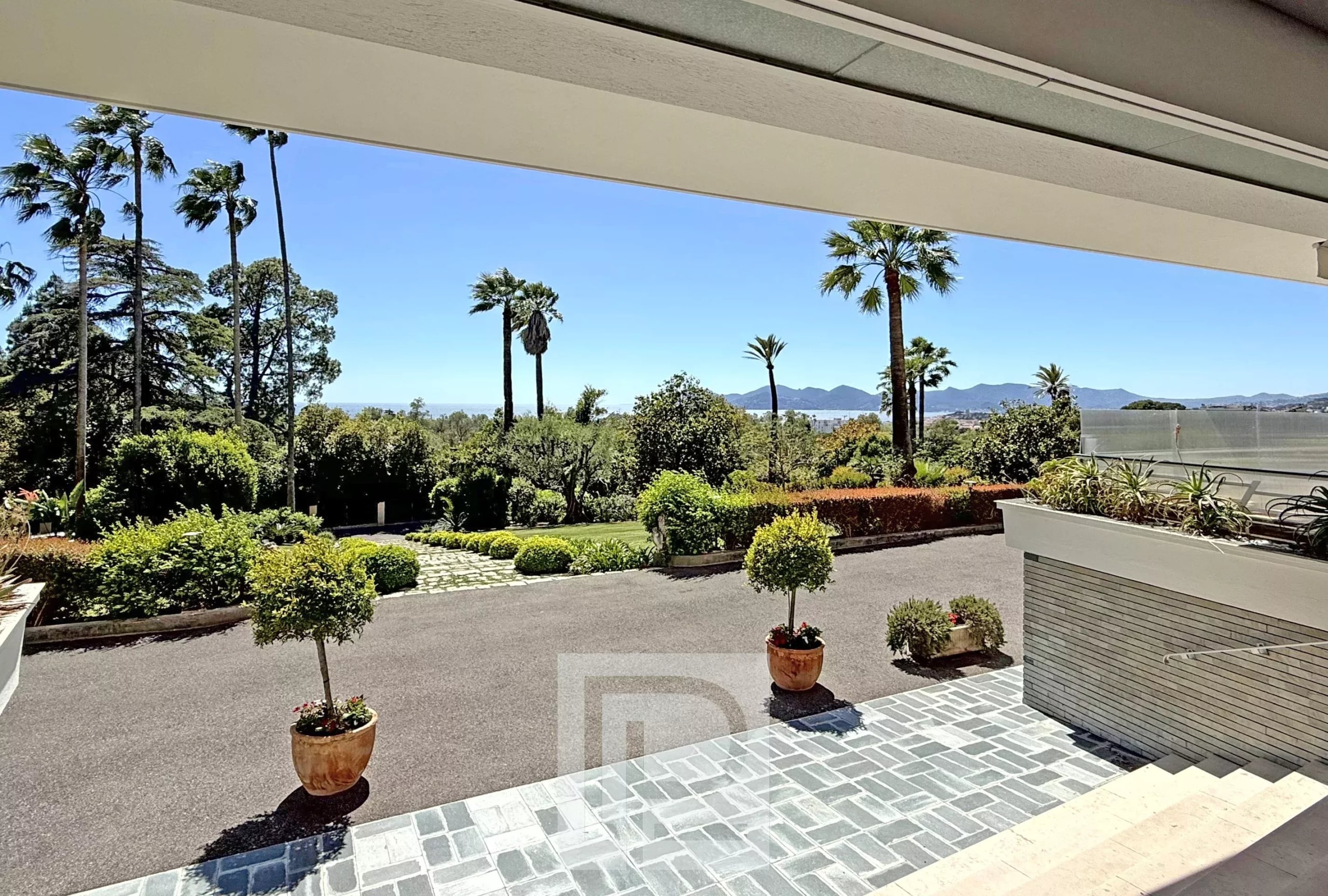 Unobstructed view of the green park and the sea from an apartment in Cannes.