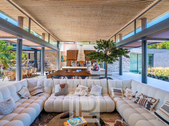 Interior of a contemporary villa with a spacious living room and open kitchen, Mougins.