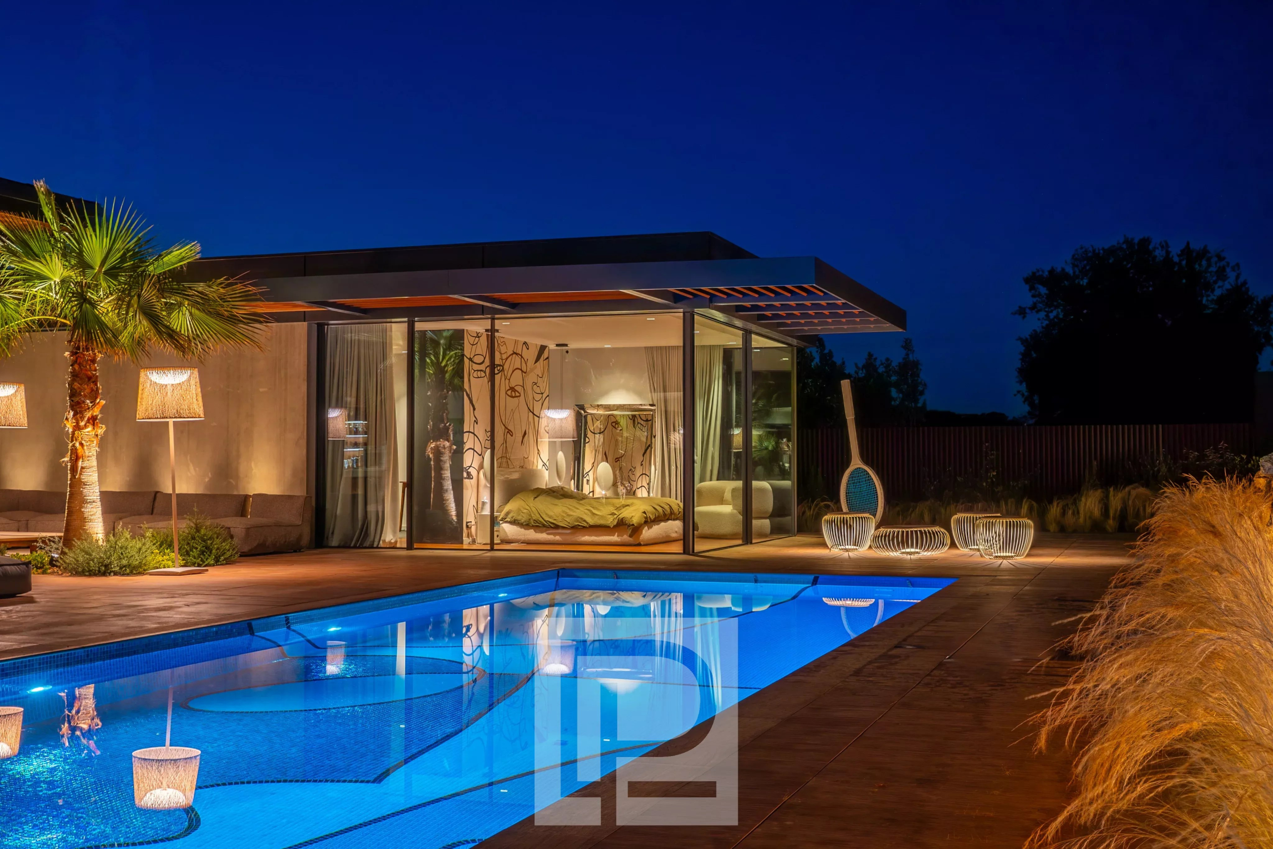 Contemporary property in Mougins Contemporary villa with swimming pool and outdoor living space in Mougins, illuminated at night.