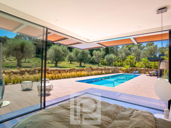 Interior of a contemporary villa overlooking the pool and garden in Mougins.