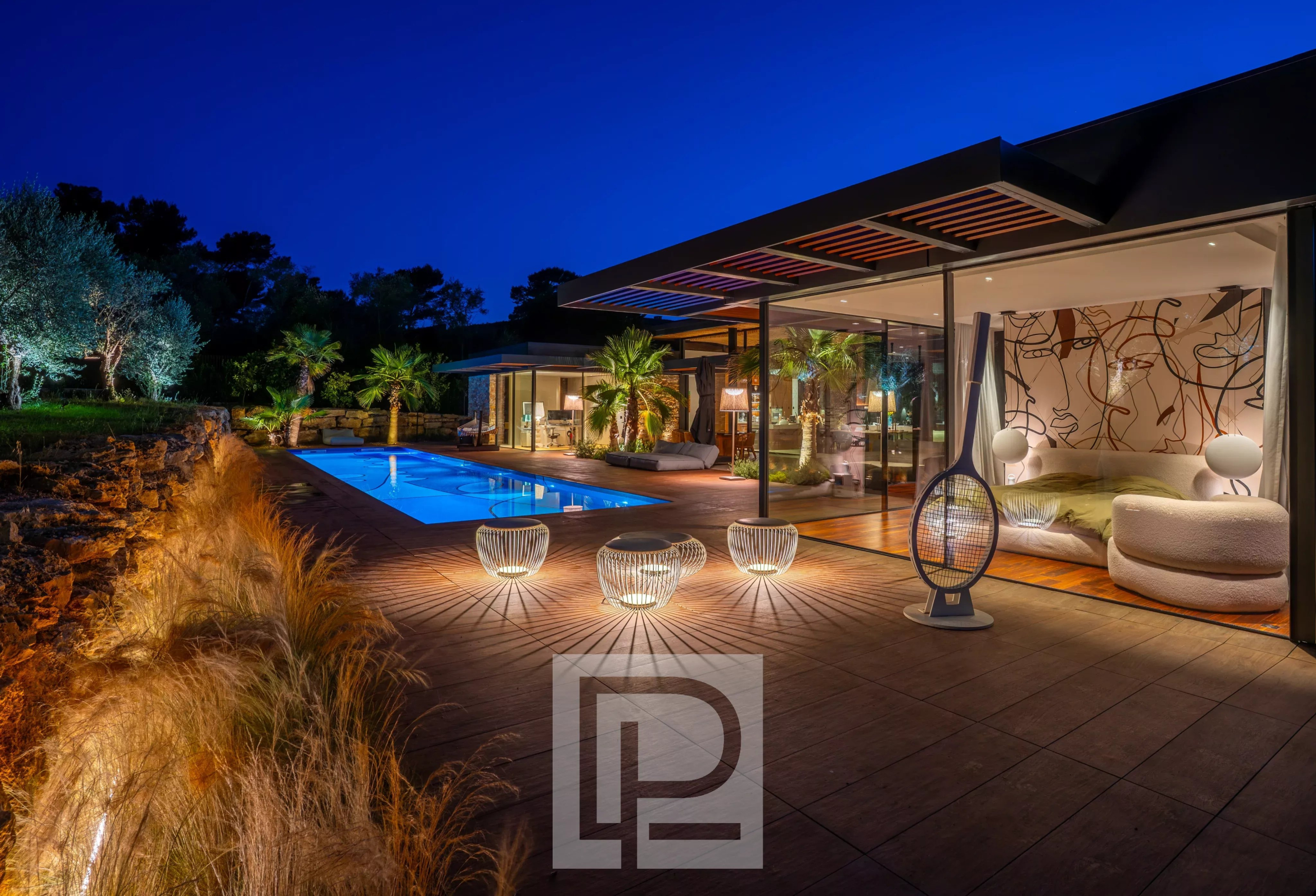 Contemporary property in Mougins Contemporary villa with swimming pool and outdoor spaces in Mougins, lit up at night.