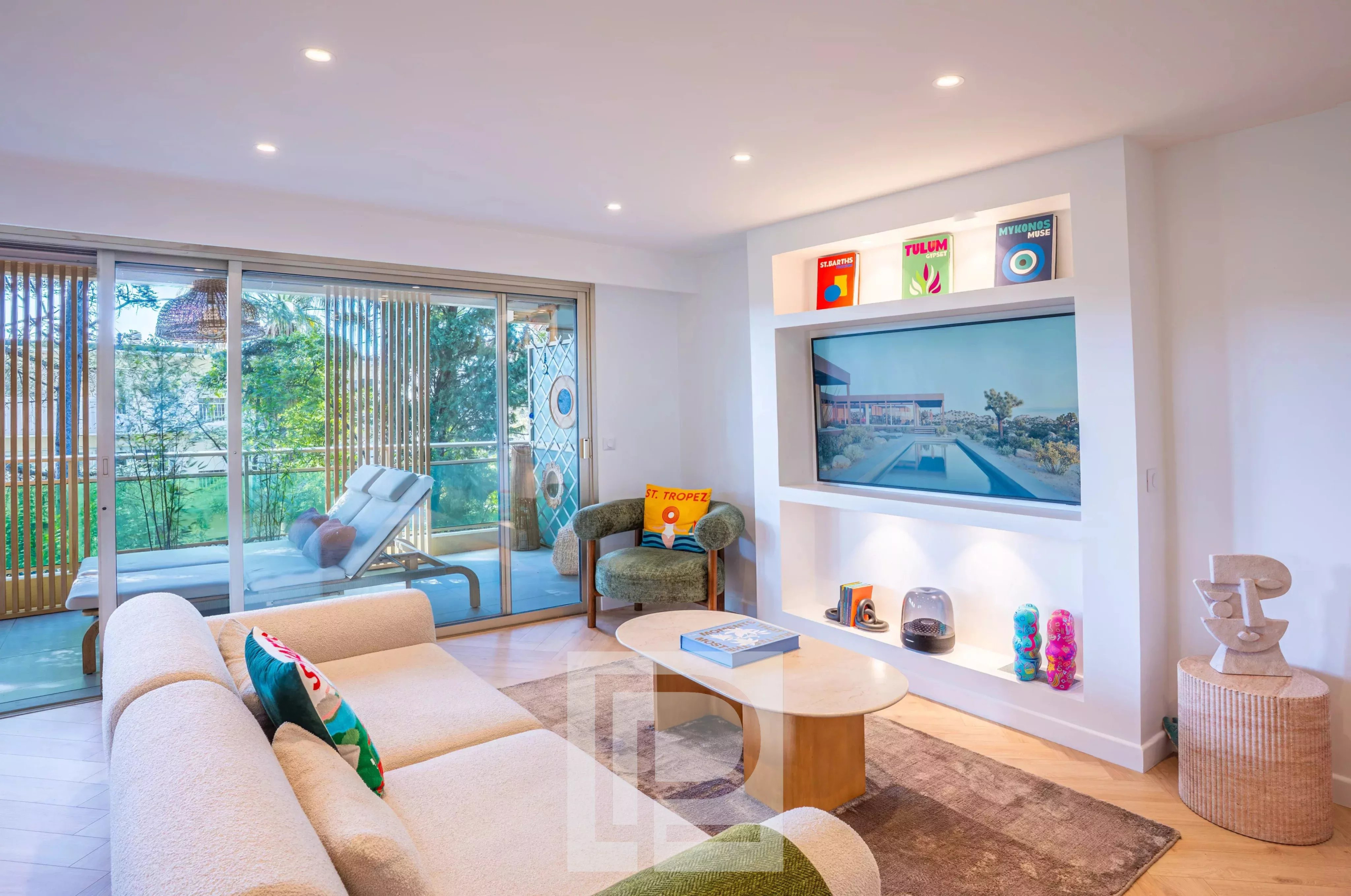 Salon contemporain à Cannes Salon d'un appartement rénové à Cannes avec vue sur le jardin, mobilier moderne et lumineux.