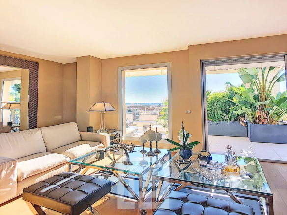 Bright living room of an apartment with an unobstructed view, decorated with plants and modern furniture.