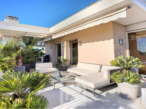Terrace of an apartment with modern furniture and plants, sunny, in Le Cannet.