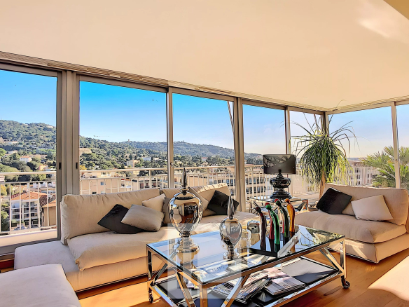 Interior of a bright apartment with views of the hills, modern furniture and comfortable living space.