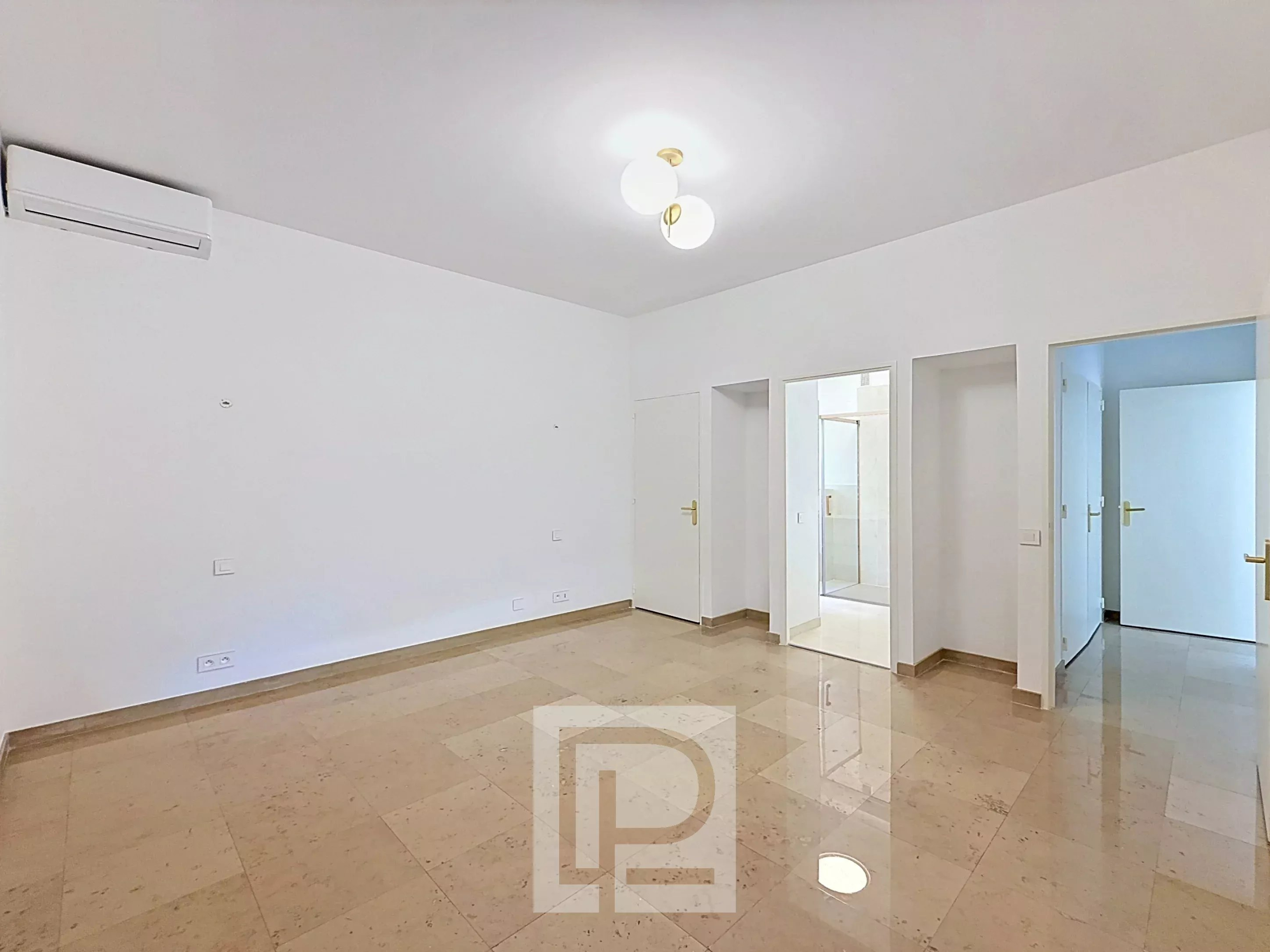 Intérieur d’un appartement à Cannes Intérieur d'un appartement lumineux avec carrelage beige et murs blancs, sans meubles.
