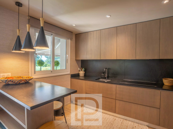 Modern kitchen with a bar and elegant lighting in a Provençal villa in Mougins.