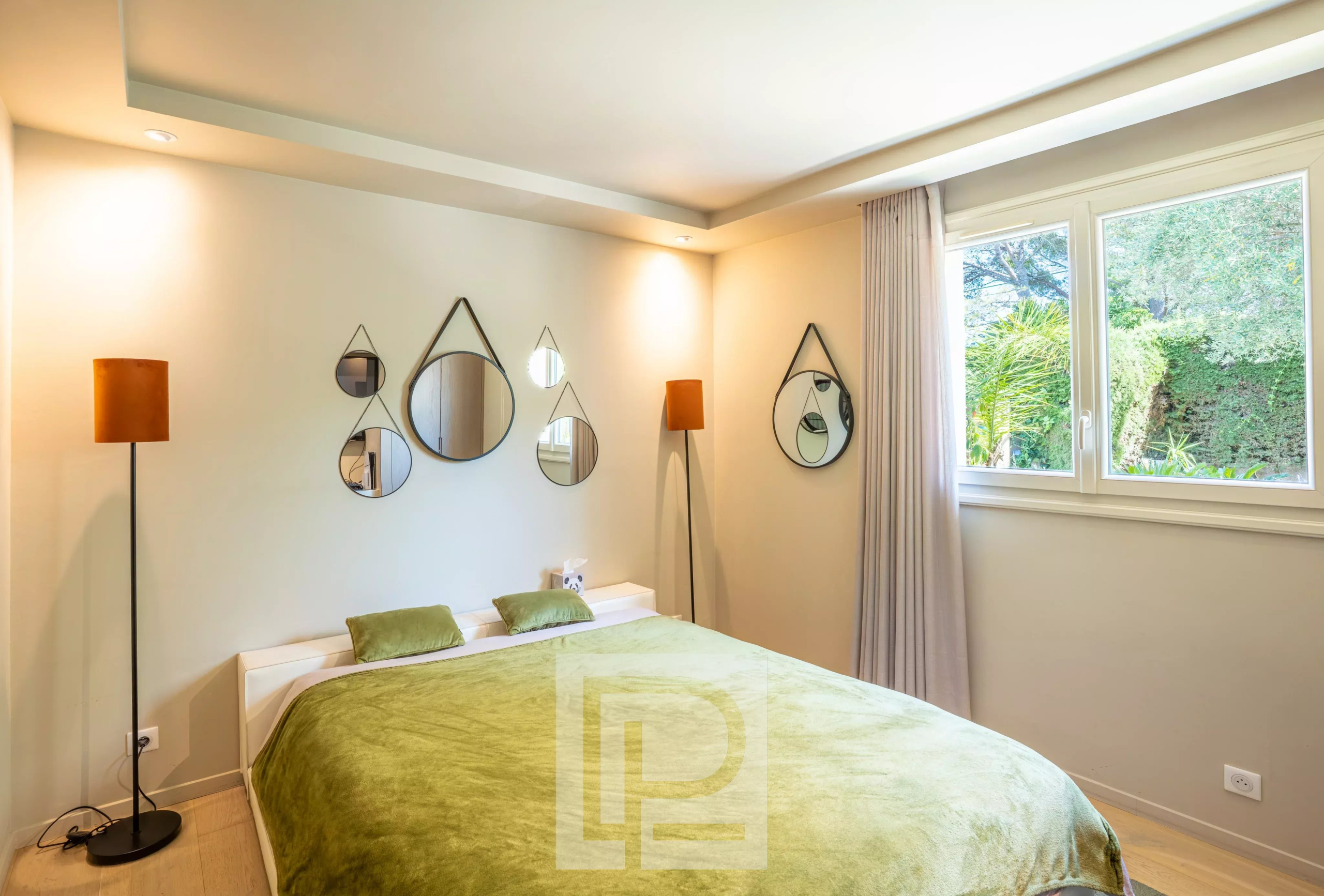 Elegant room in a villa in Mougins Room in a renovated Provençal villa with modern decor and garden view.