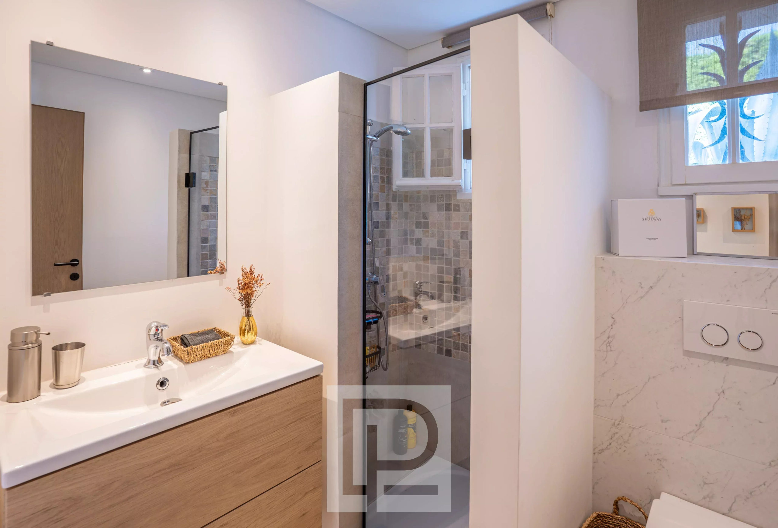 Renovated bathroom Modern bathroom with shower and light wood furniture.