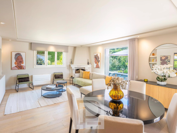 Interior of a renovated Provençal villa with a bright living room and a fireplace in Mougins.