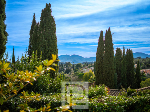Vue dégagée sur des cèdres et des collines depuis une villa contemporaine à Mougins.