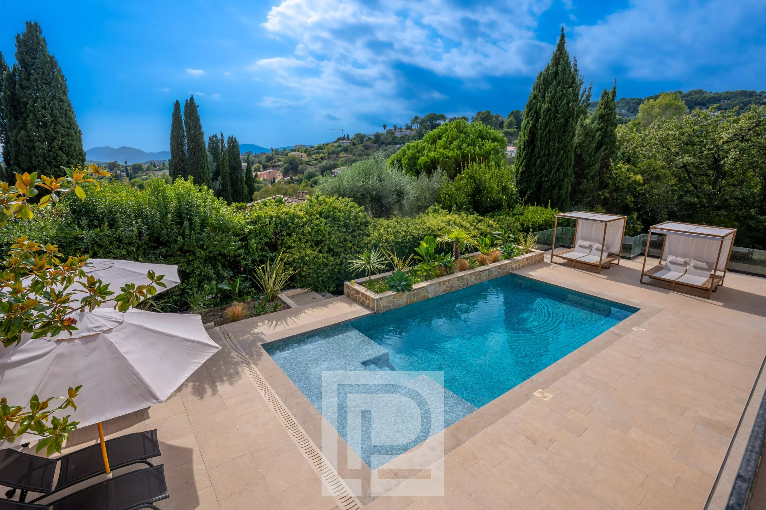 Villa contemporaine avec piscine à Mougins Piscine et espace extérieur d'une villa contemporaine à Mougins, avec des chaises longues et des parasols.