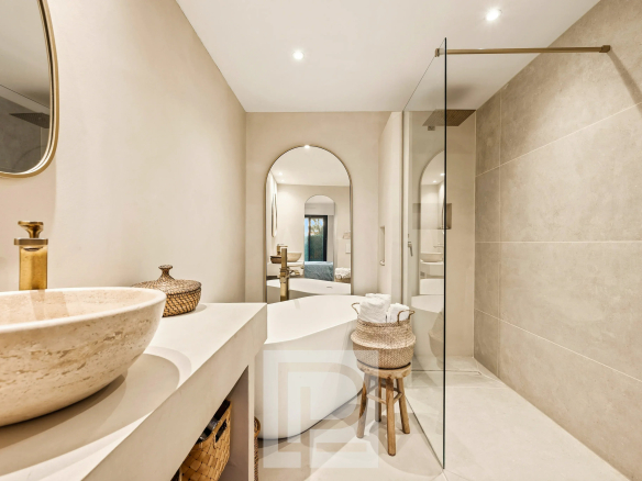 Salle de bain moderne avec douche à l'italienne et lavabo en pierre.