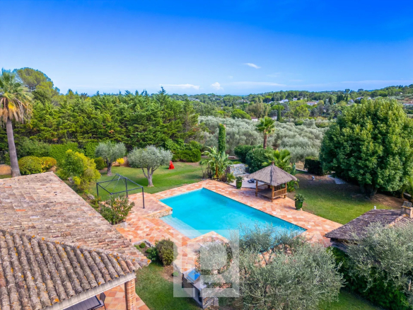 Aerial view of a property with swimming pool and landscaped grounds in Mouans-Sartoux.