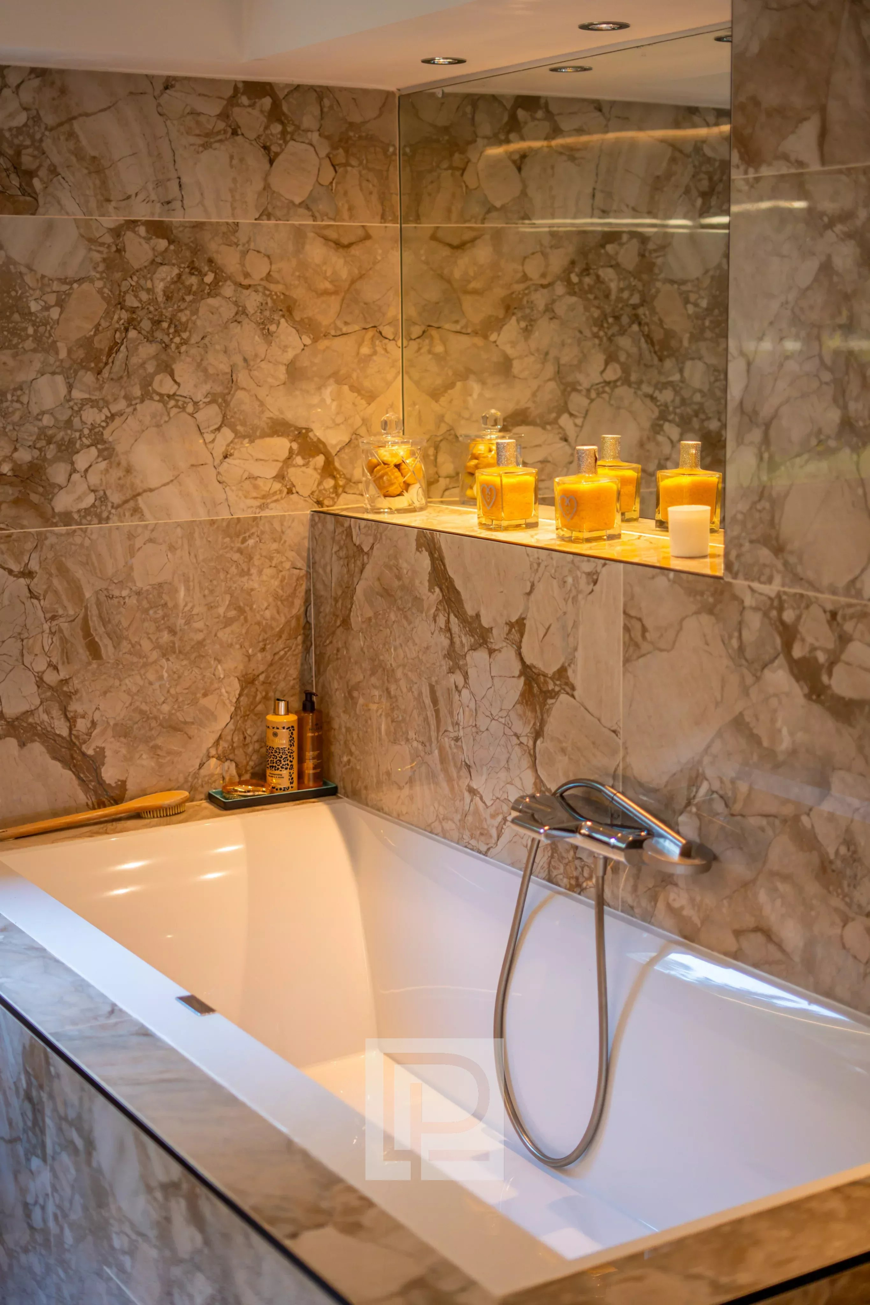 Salle de bain moderne avec baignoire et décor en marbre.