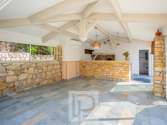 Interior of a villa with stone walls and exposed beam ceiling.