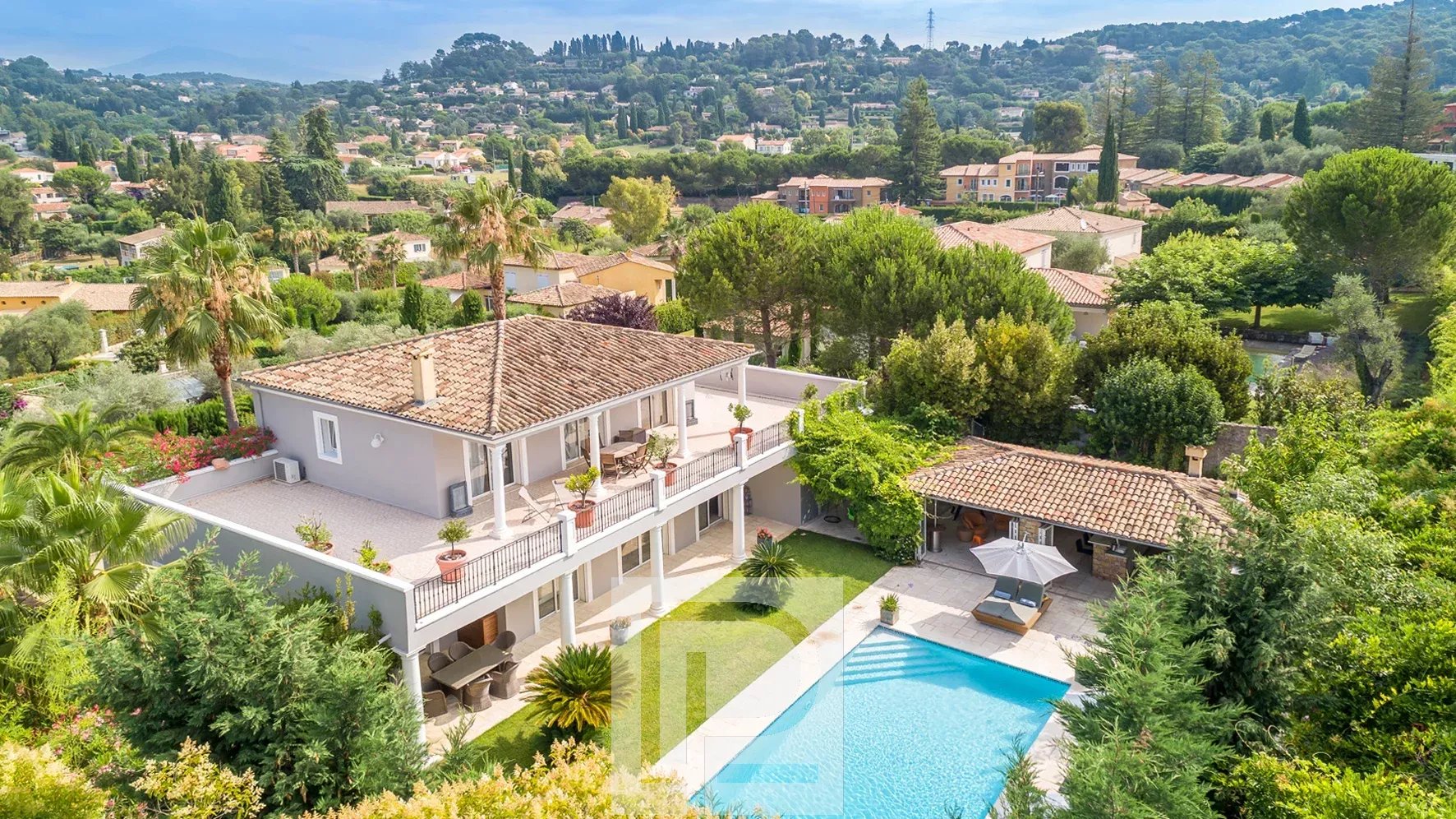Family villa in Mougins Aerial view of a villa with swimming pool and garden in a residential estate in Mougins.