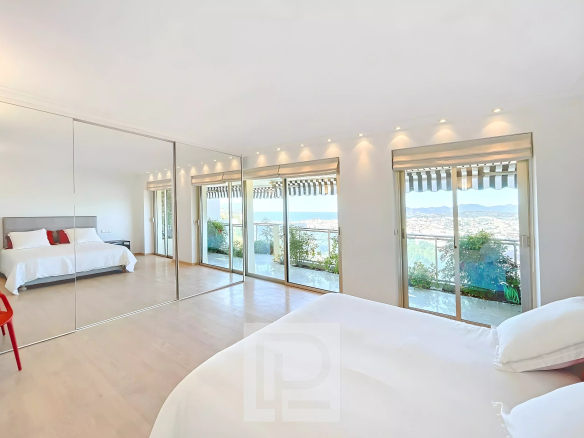 Chambre lumineuse avec vue sur la mer, grandes baies vitrées et terrasse au Cannet.