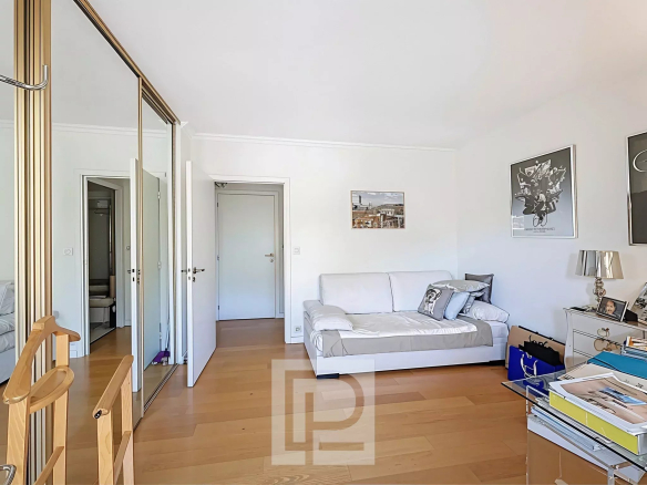 Interior of a 3-room apartment with sofa, storage unit and natural light.